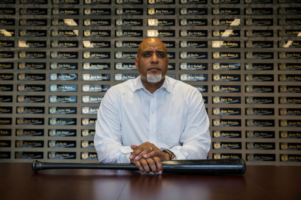 a man sitting at a table with a bat